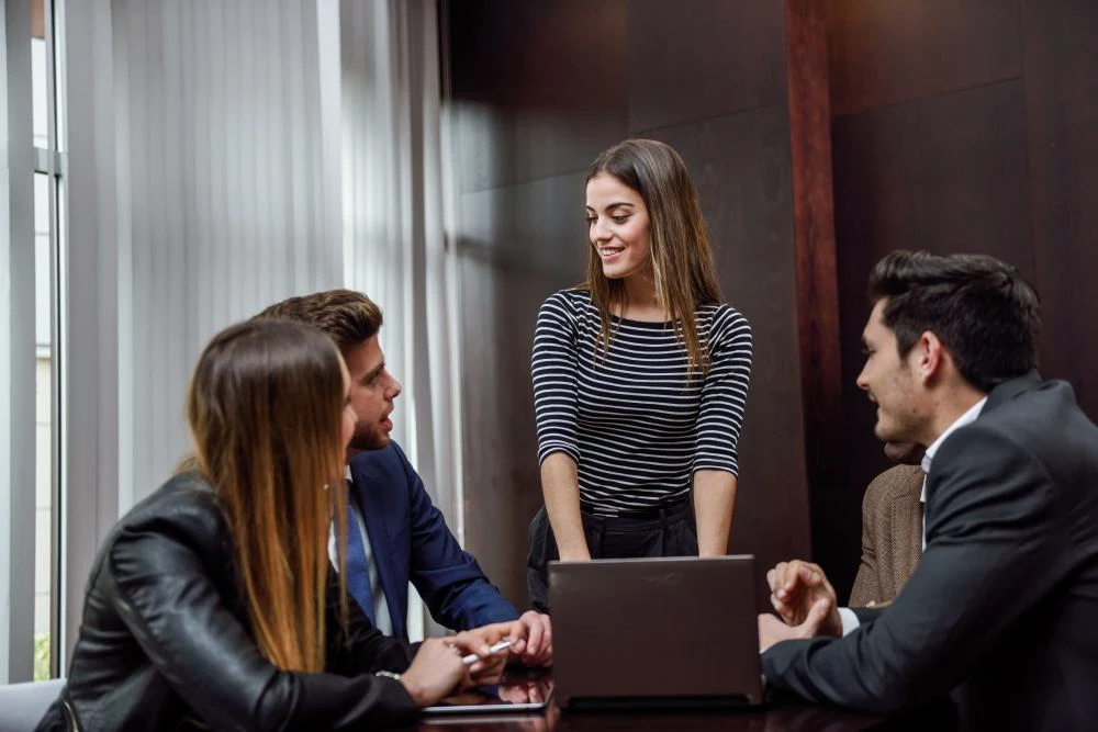 Business team collaborating around a laptop